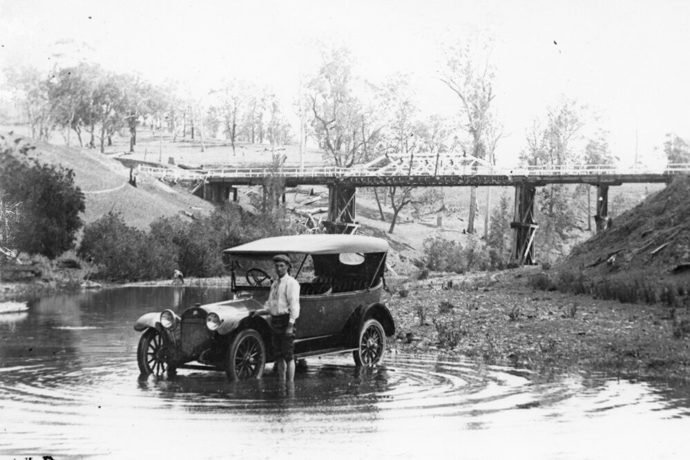 Car in waterhole, 1910, black & white photograph